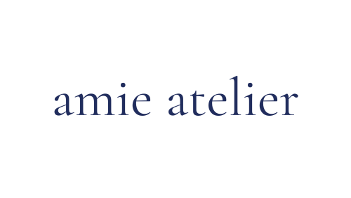 logo for amie atelier with blue writing and white background, all lowercase.